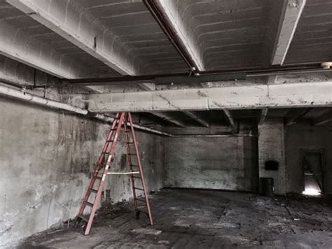 steel box encased in the concrete floor of office|conduit on concrete floor.